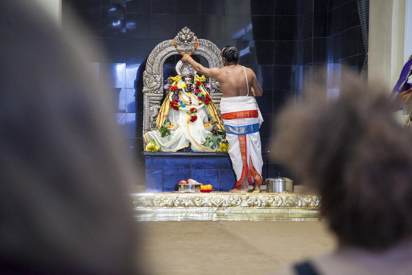 Person draping an altar with flowers